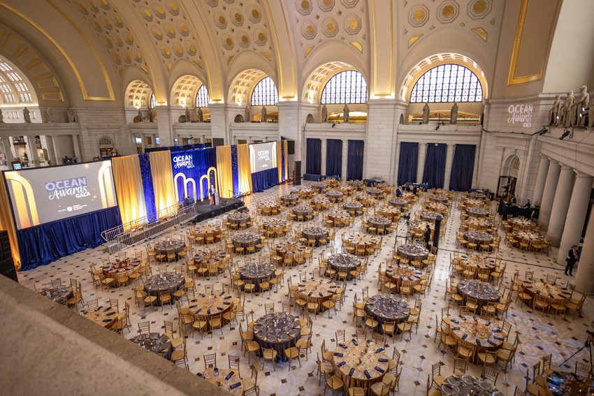 Corporate Event in Main Hall-East with Trees, Hanging Greenery, Floral Centerpieces, and Candlelight.